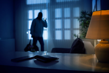 man in dark home committing burglary