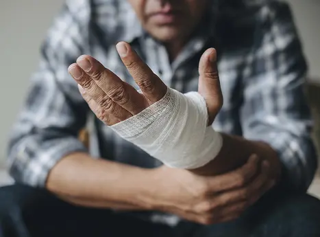 man with bandaged injured hand