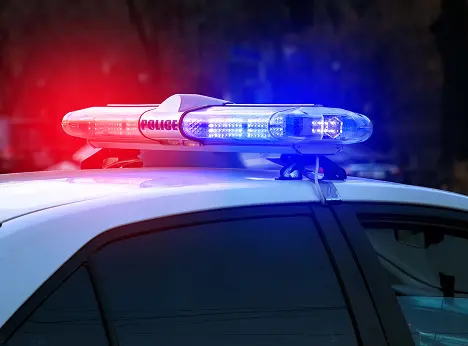 police lights flashing atop car
