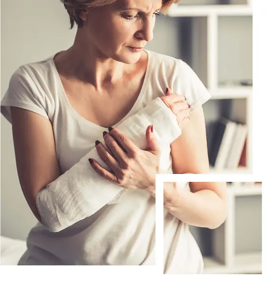woman holding her bandaged, injured arm