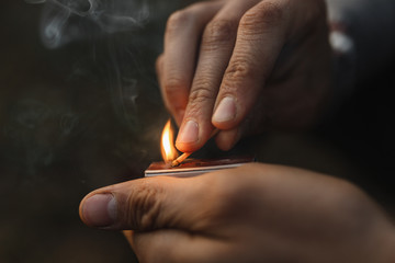 person lighting match